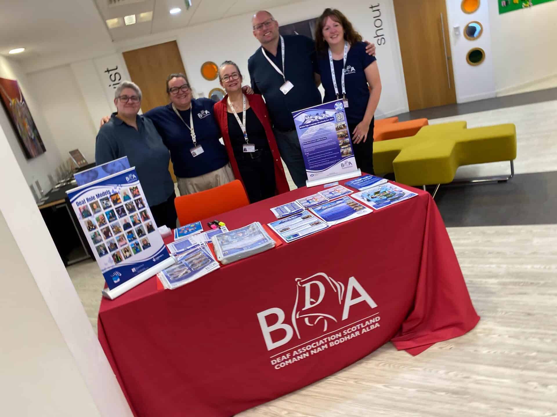 Group of people at BSL Scotland Act 2015 information stand.