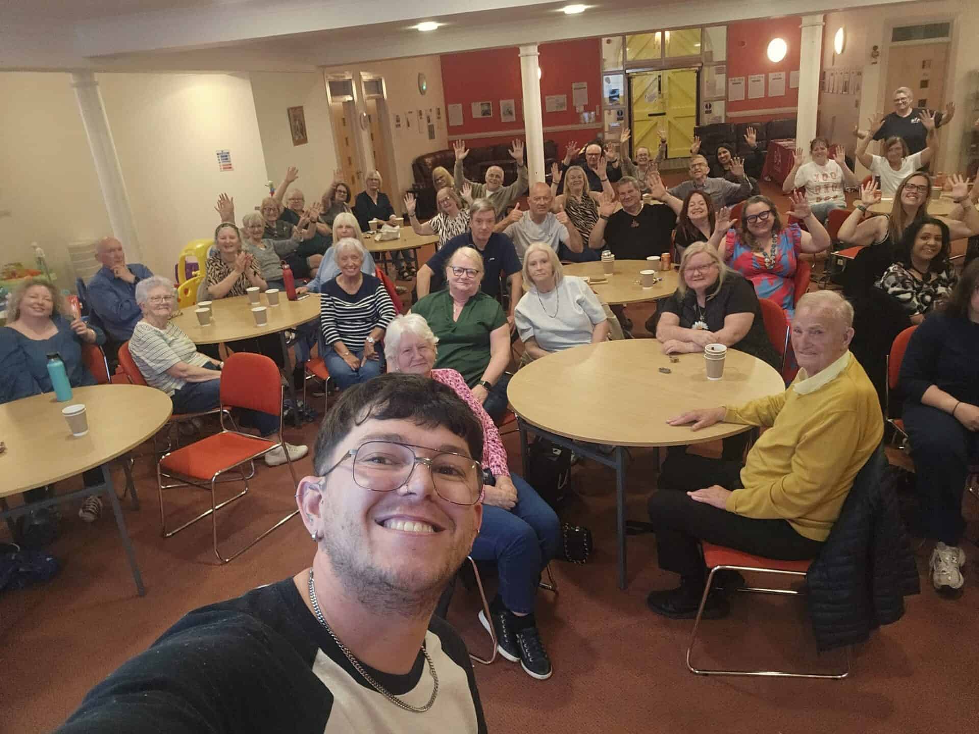 Group of people at community event celebrating BSL (Scotland) Act 2015.