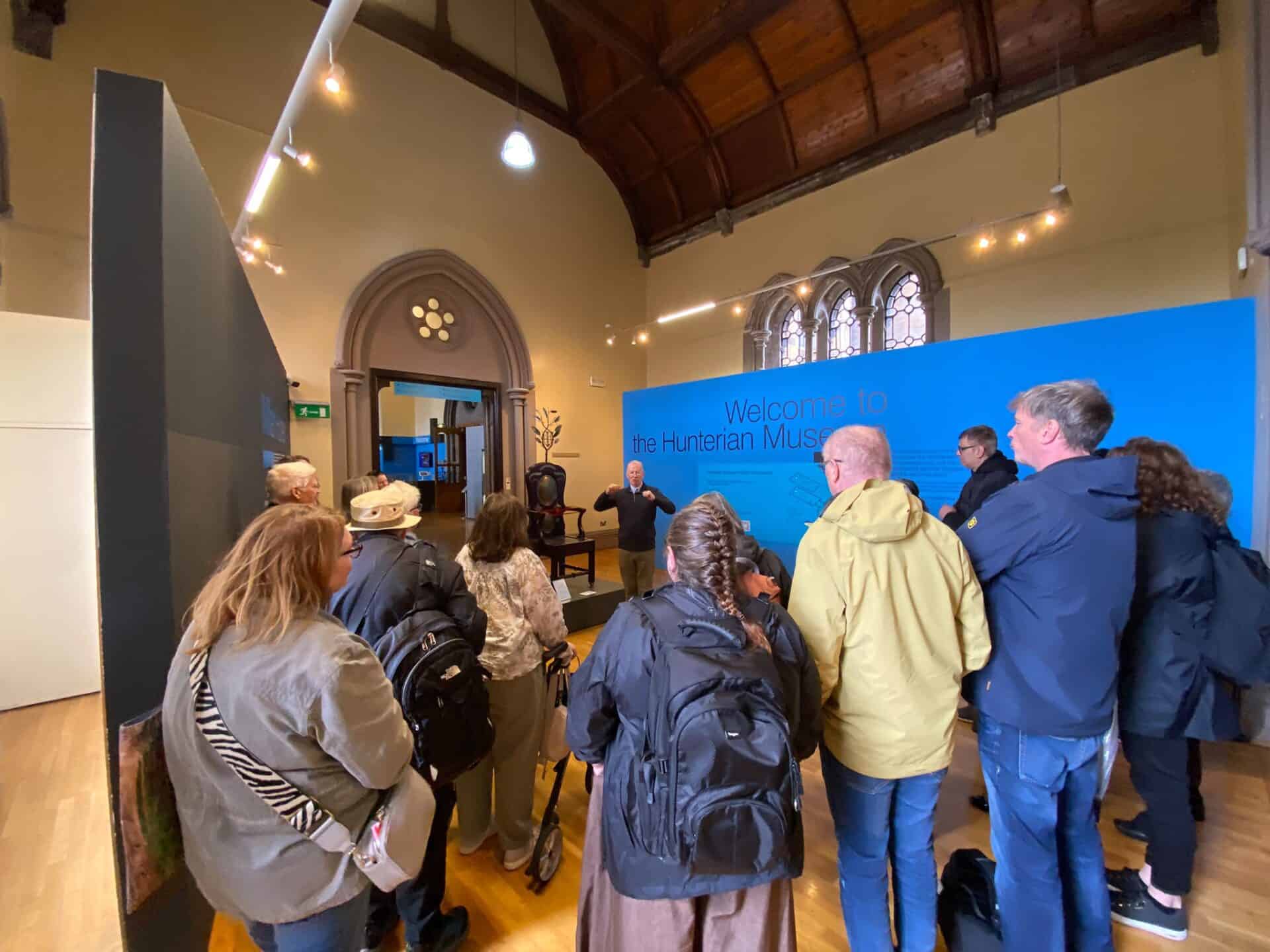 People attending a BSL Act 2015 event in a historic building in Scotland.