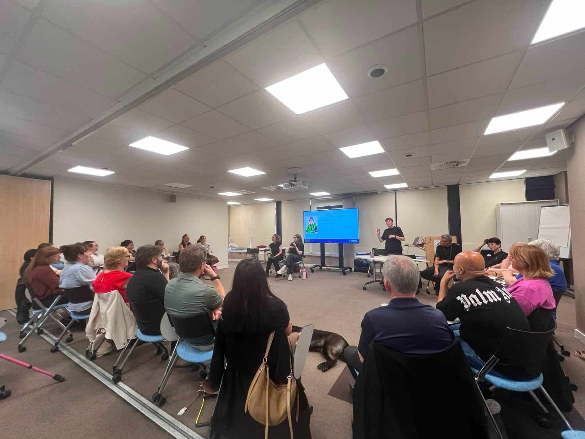 People attending a BSL Act 2015 awareness session in a conference room.