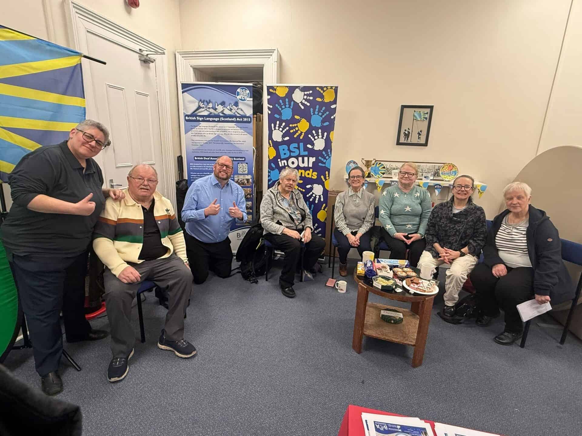 Group of people at BSL Act 2015 awareness event in Scotland.